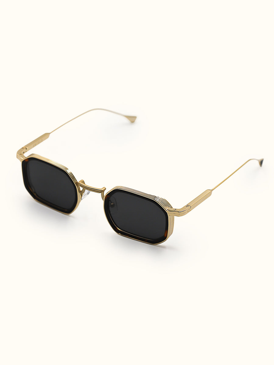 Gold-framed sunglasses with black lenses on a white background