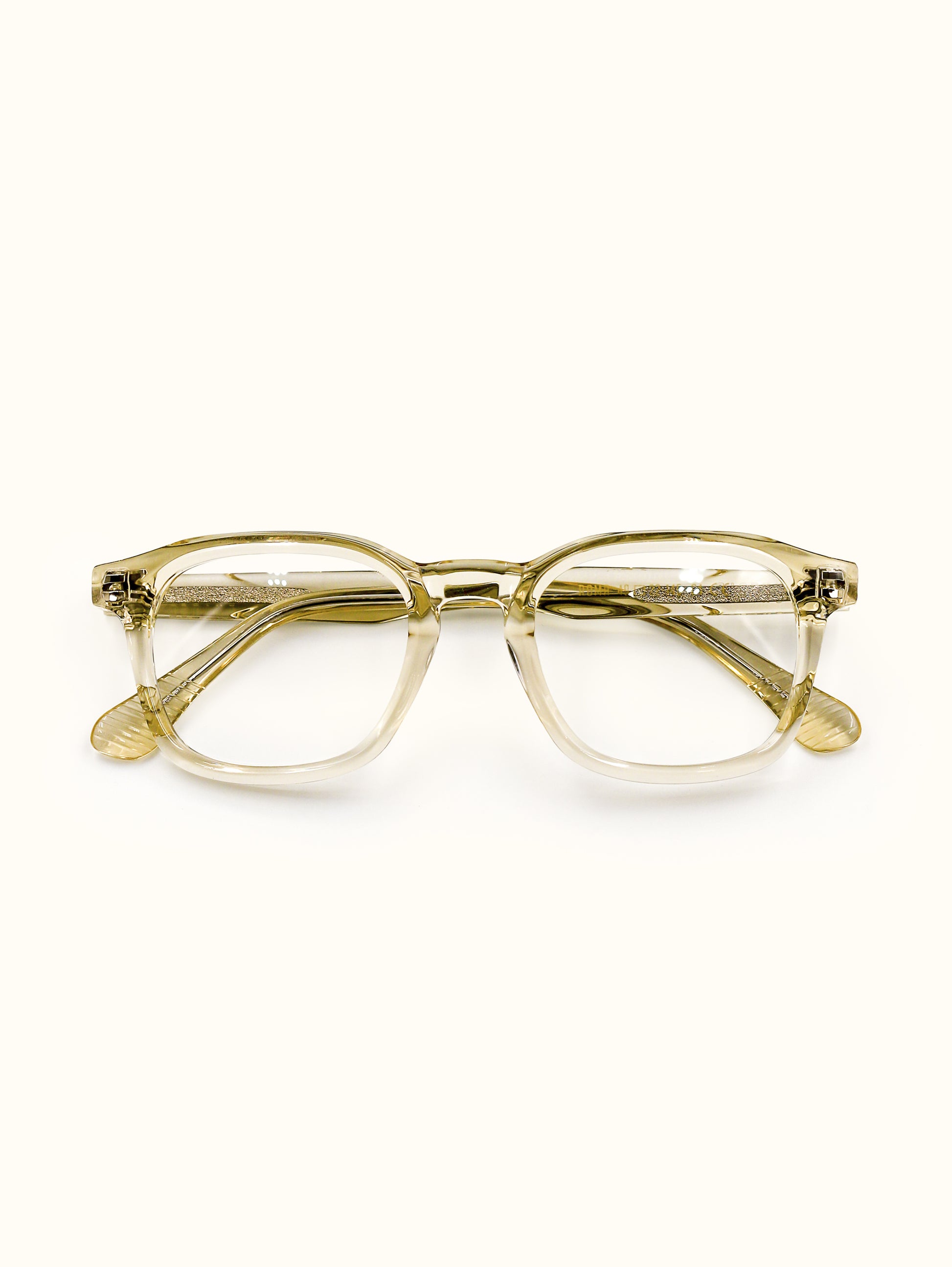 Gold-framed eyeglasses on a white background