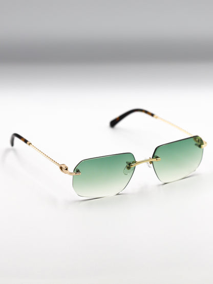Sunglasses with gold frame and green gradient lenses on a light gray background