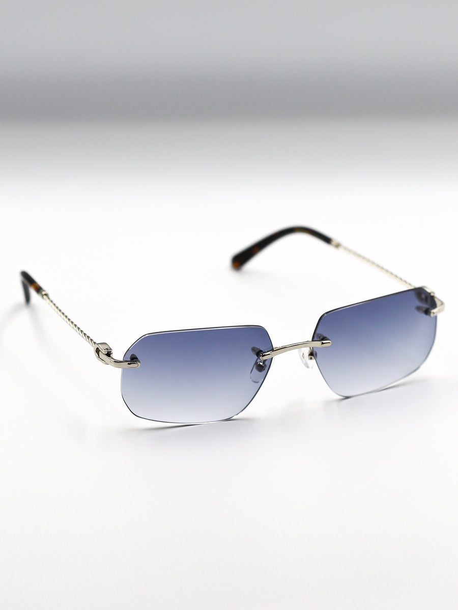 Sunglasses with gradient blue lenses and thin gold frame on a light gray background