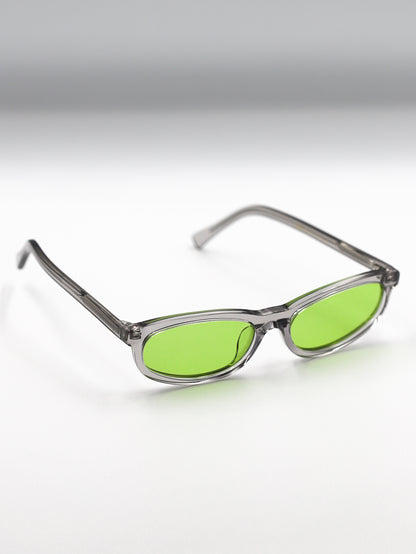 Sunglasses with green lenses and clear frames on a gradient background