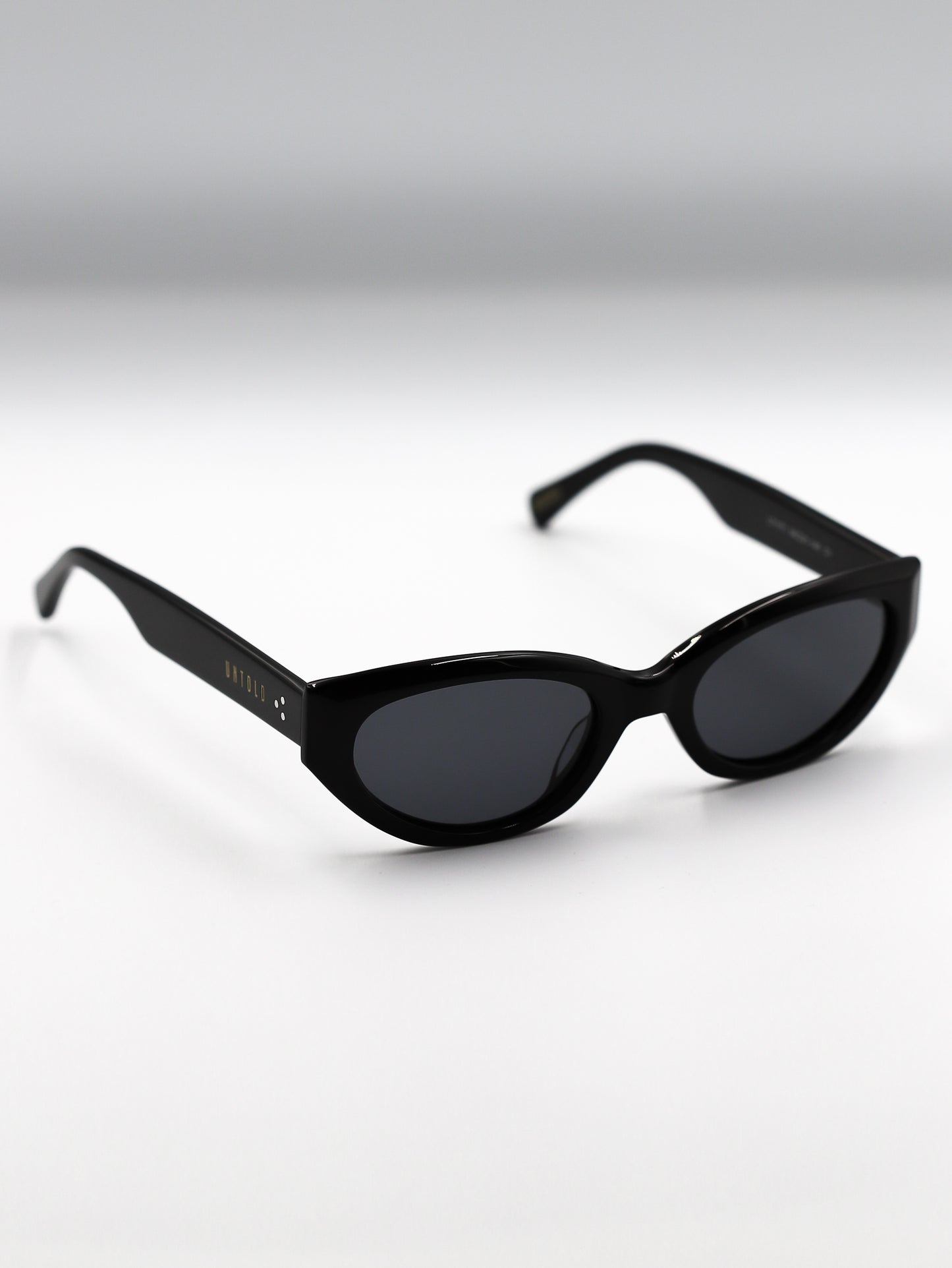 Black sunglasses on a gradient gray background