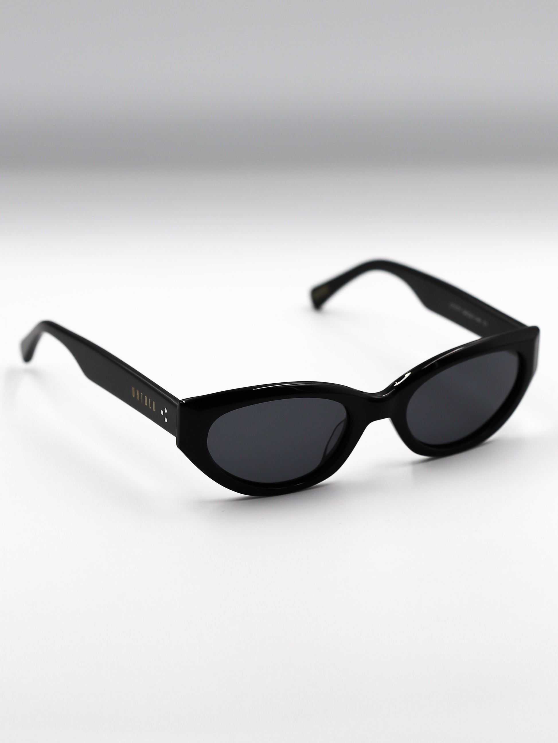 Black sunglasses on a gradient gray background