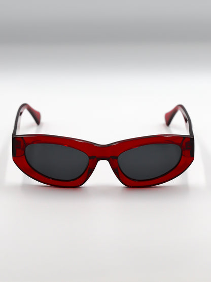 Red sunglasses with dark lenses on a white background