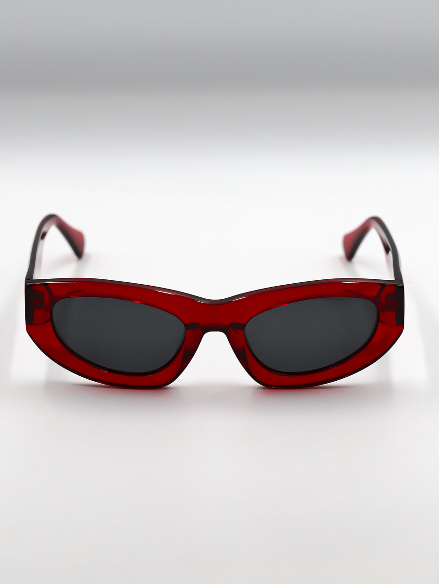 Red sunglasses with dark lenses on a white background