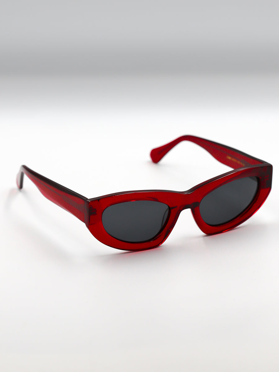 Red sunglasses with black lenses on a white background