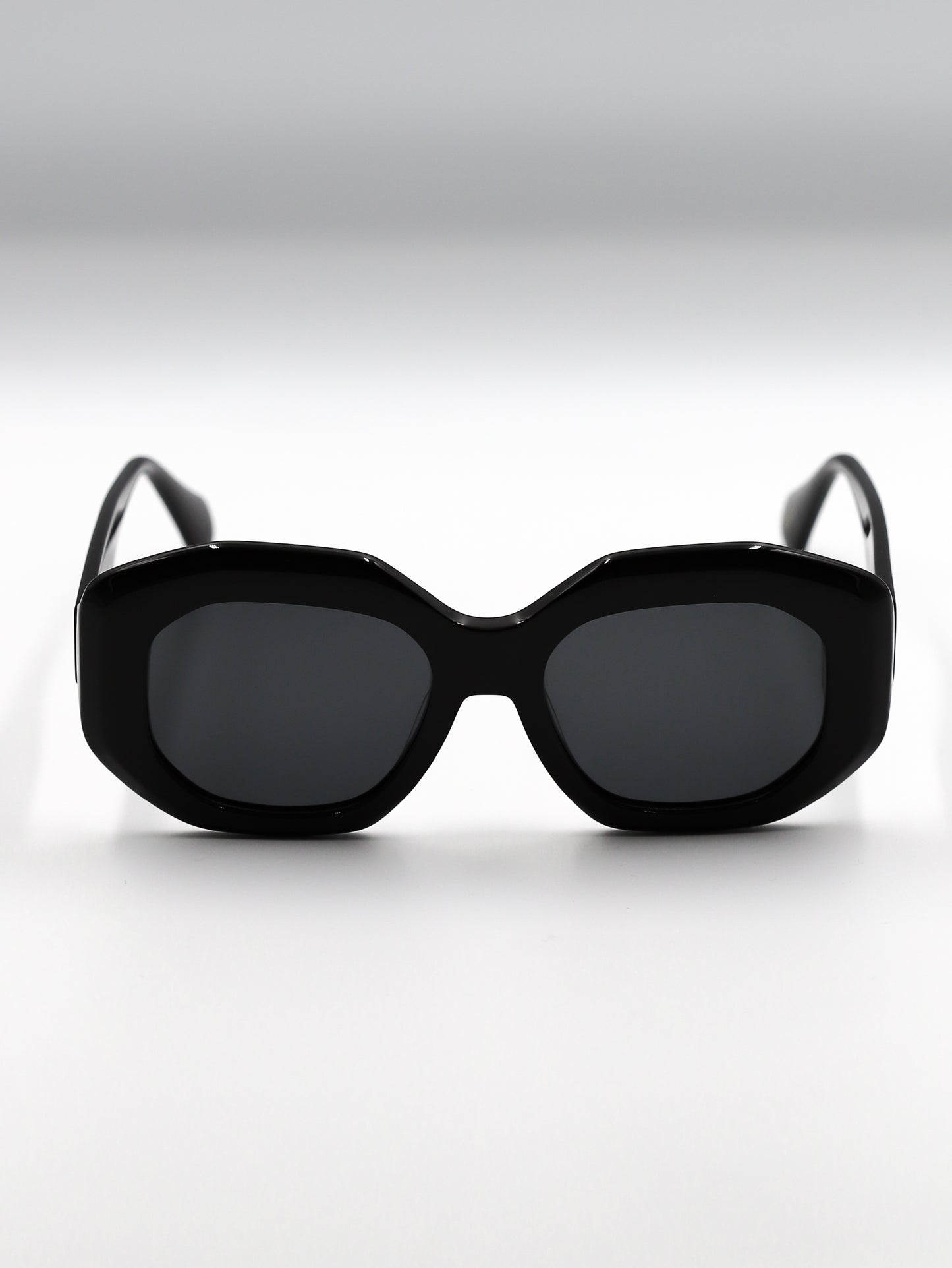 Black sunglasses with a cat-eye design on a white background
