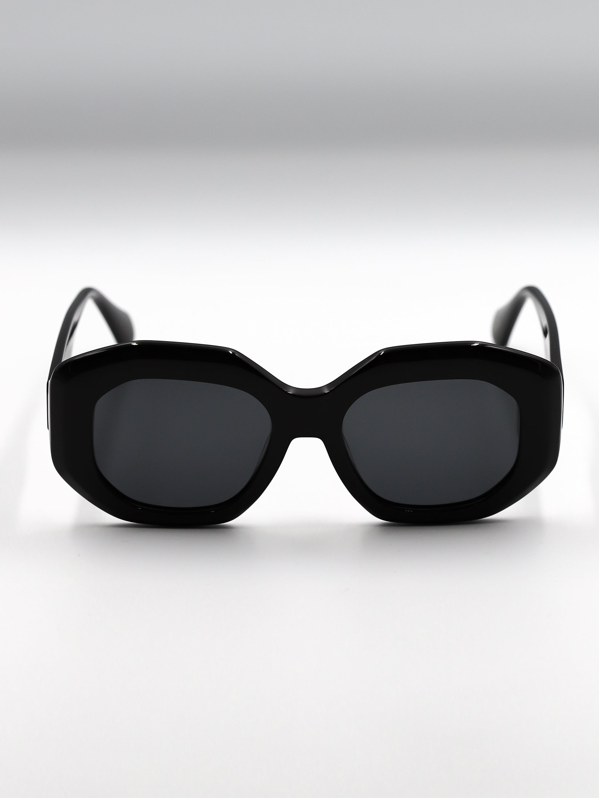 Black sunglasses with a cat-eye design on a white background