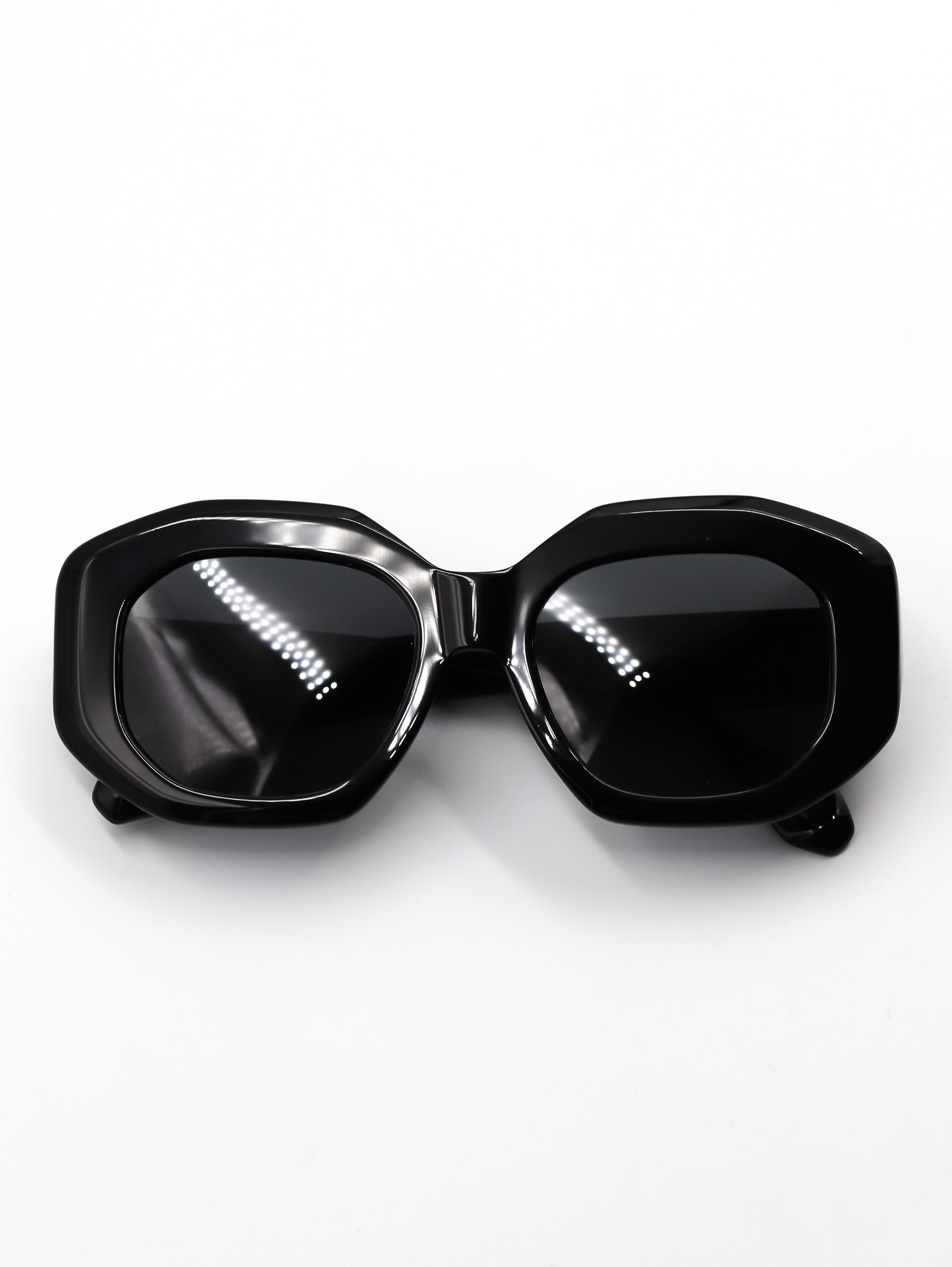 Black sunglasses with a reflective surface on a white background