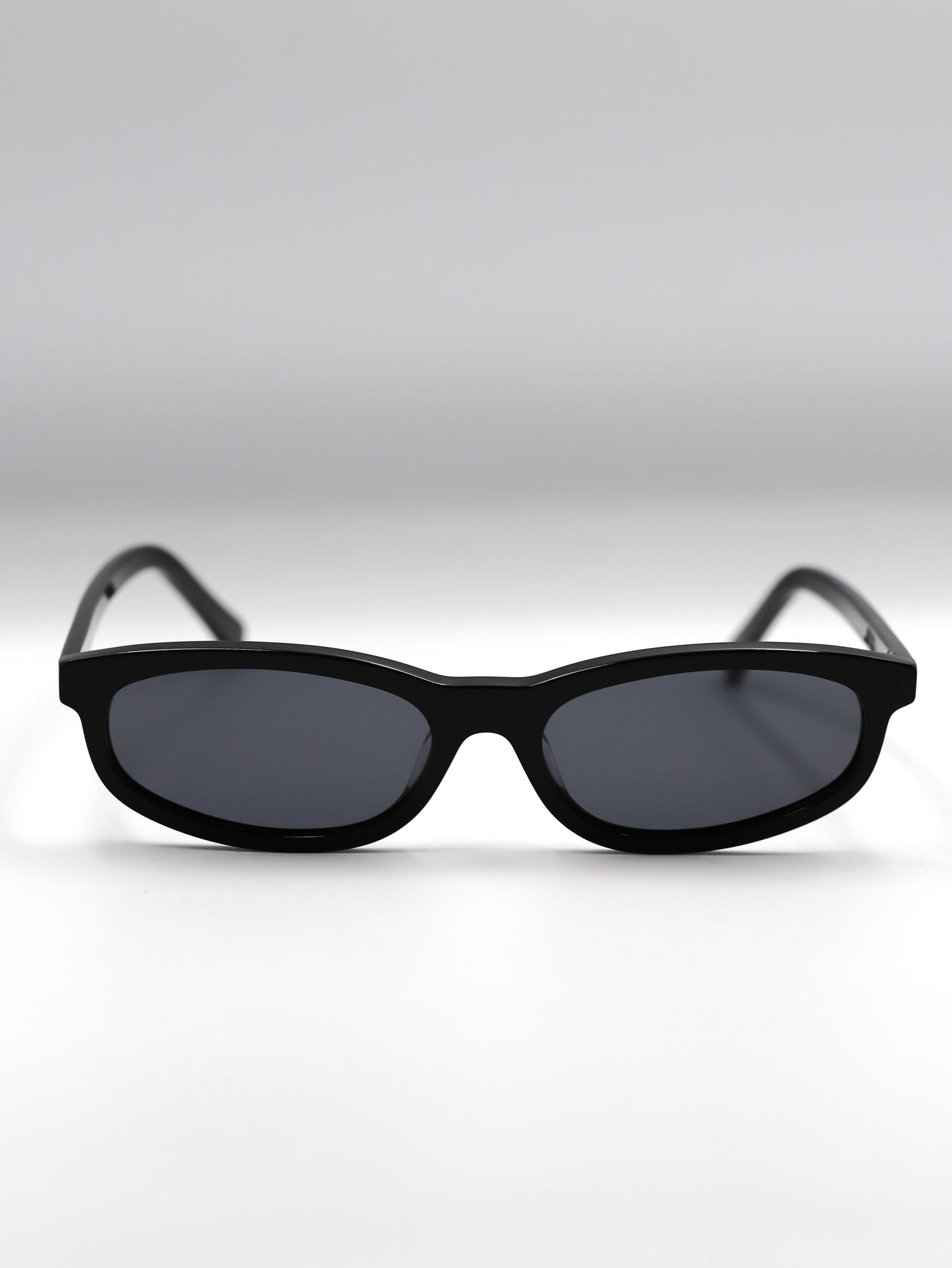 Black sunglasses on a light gray background