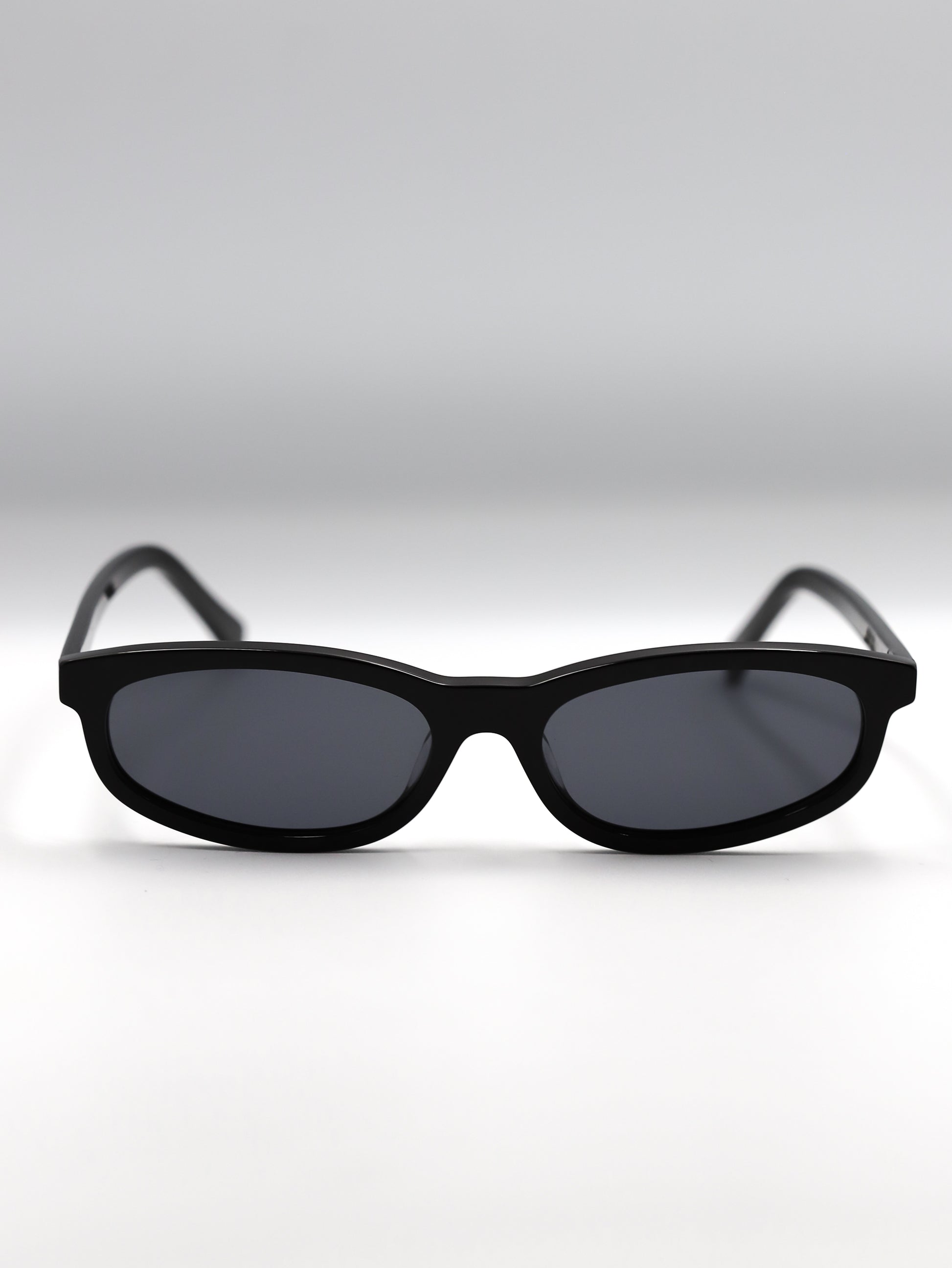 Black sunglasses on a light gray background