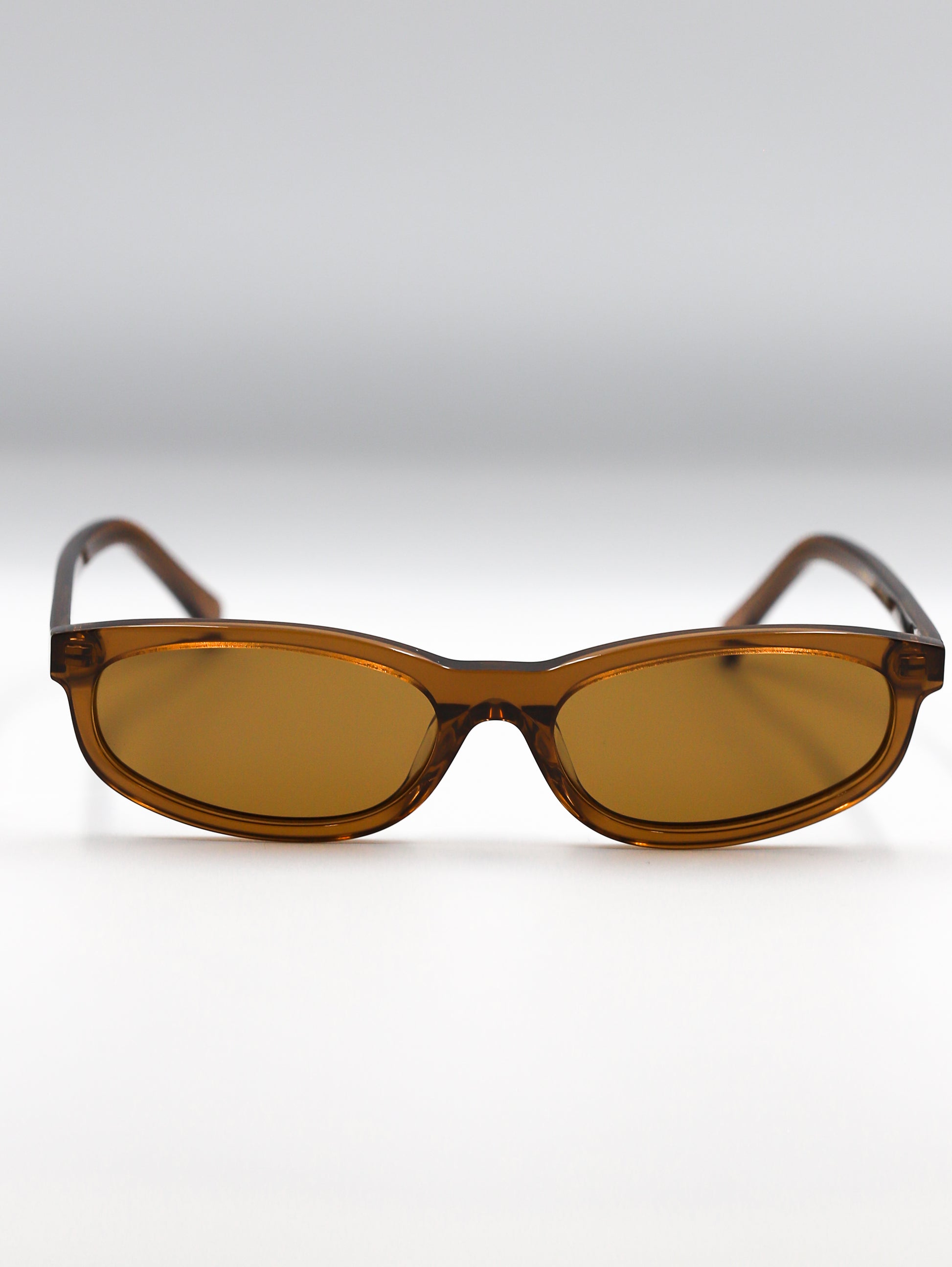 Brown sunglasses with a gradient effect on a white background