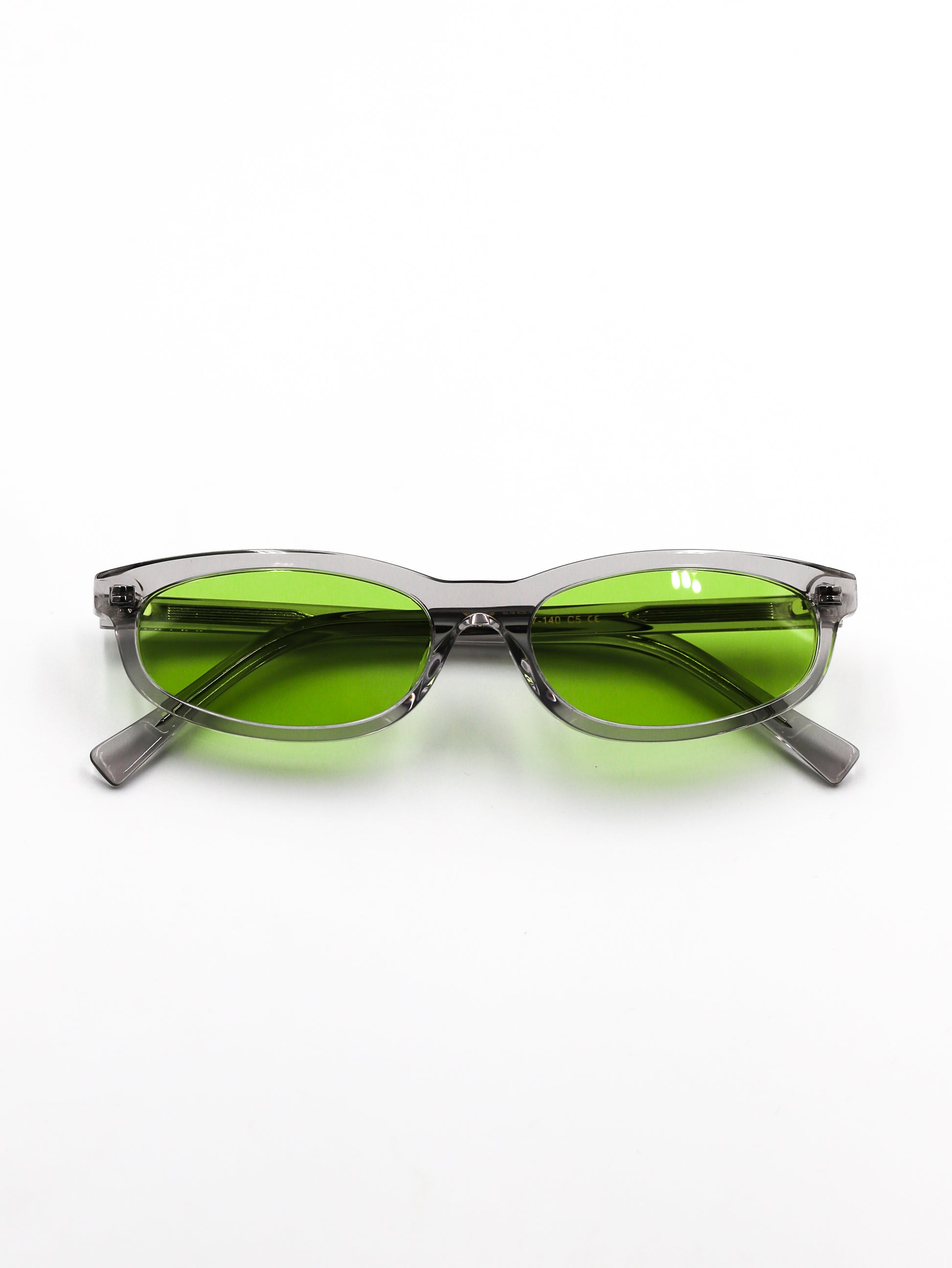Sunglasses with green lenses and gray frames on a white background