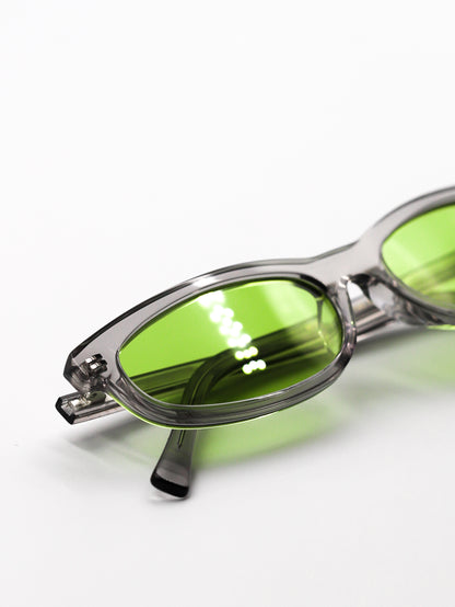 Sunglasses with green lenses and gray frames on a white background