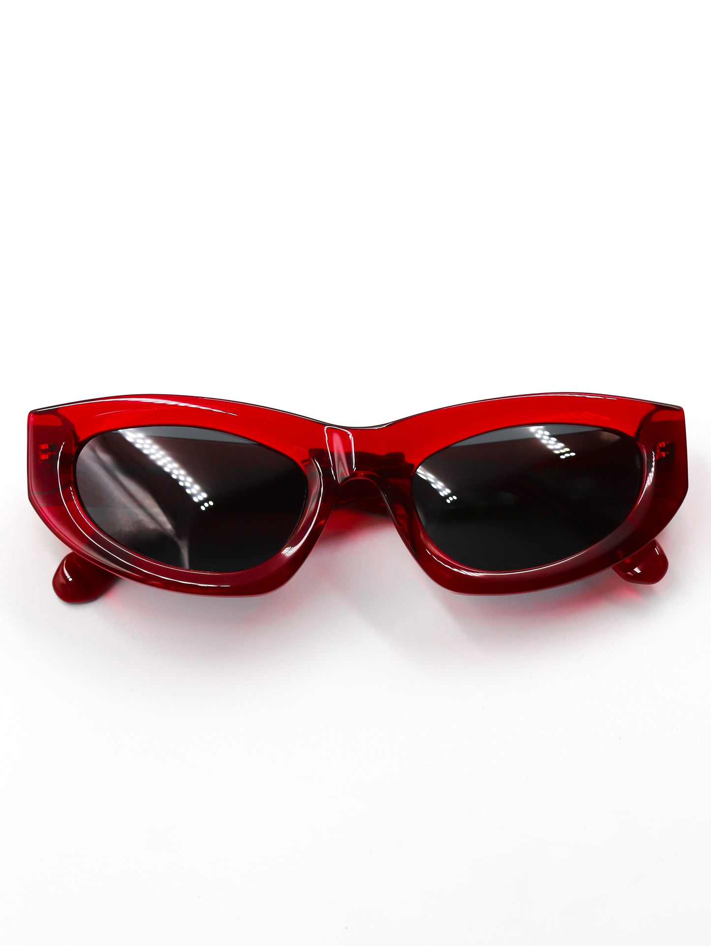 Red sunglasses with black lenses on a white background