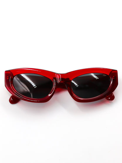 Red sunglasses with black lenses on a white background