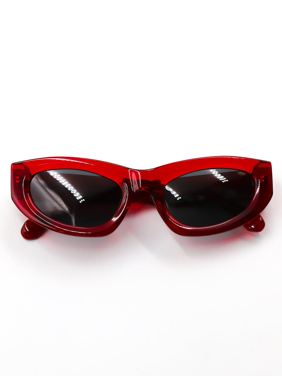 Red sunglasses with black lenses on a white background