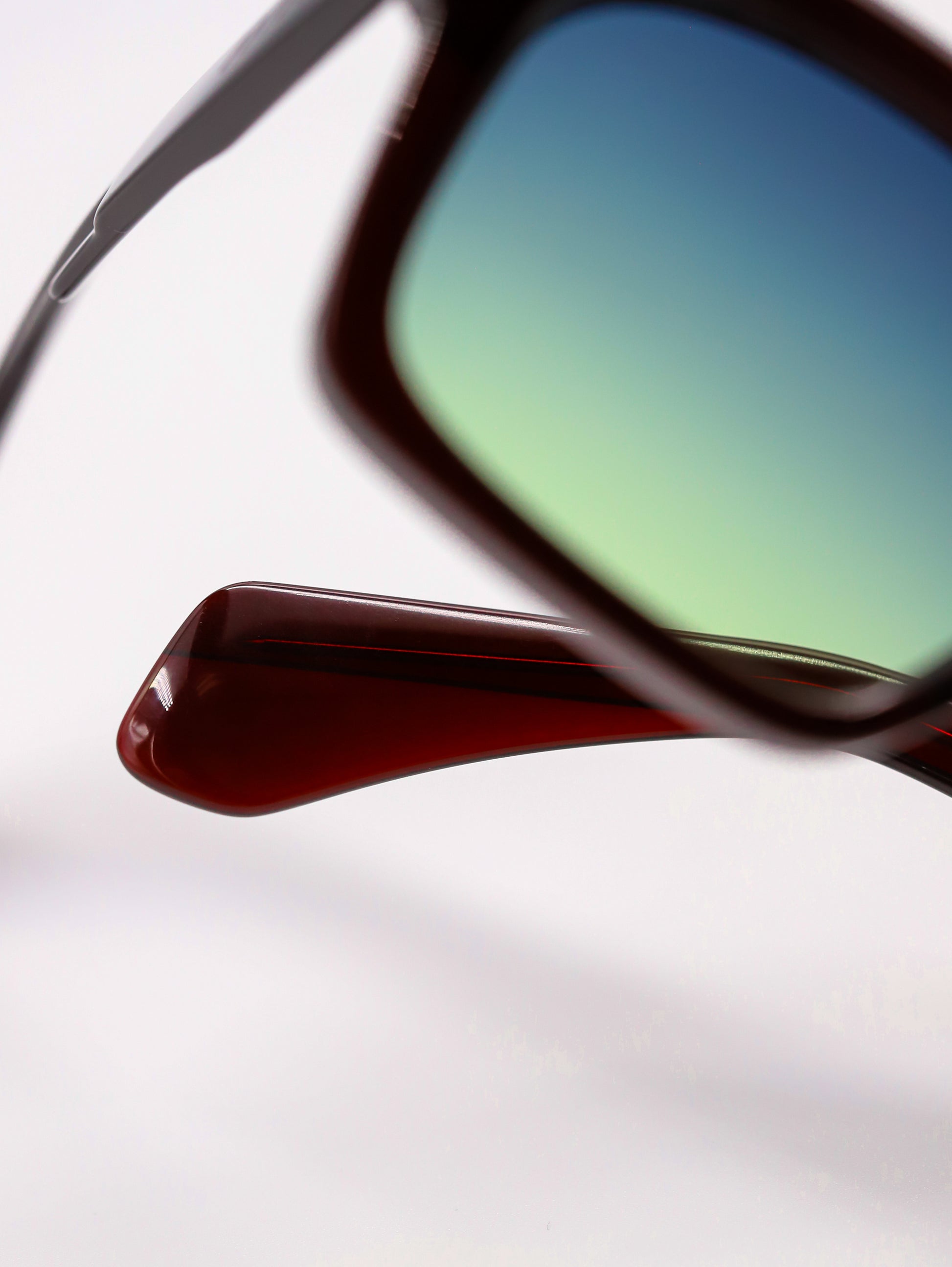 Close-up of a sunglasses reflecting a blurred background