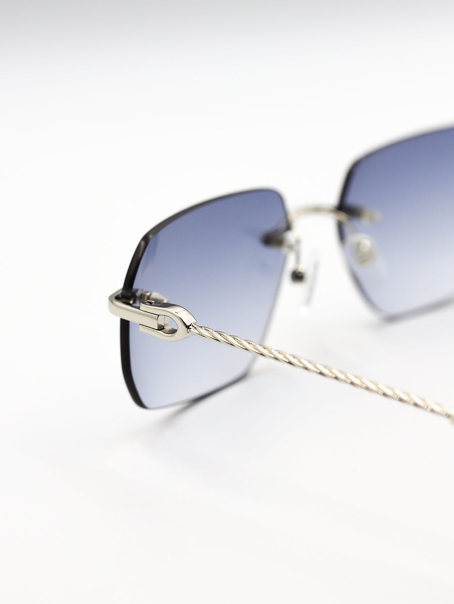 Sunglasses with gradient blue lenses and gold frame on a white background