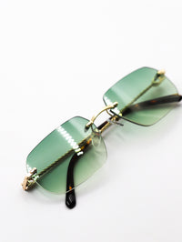 Thumbnail for Green sunglasses with gold frames on a white background