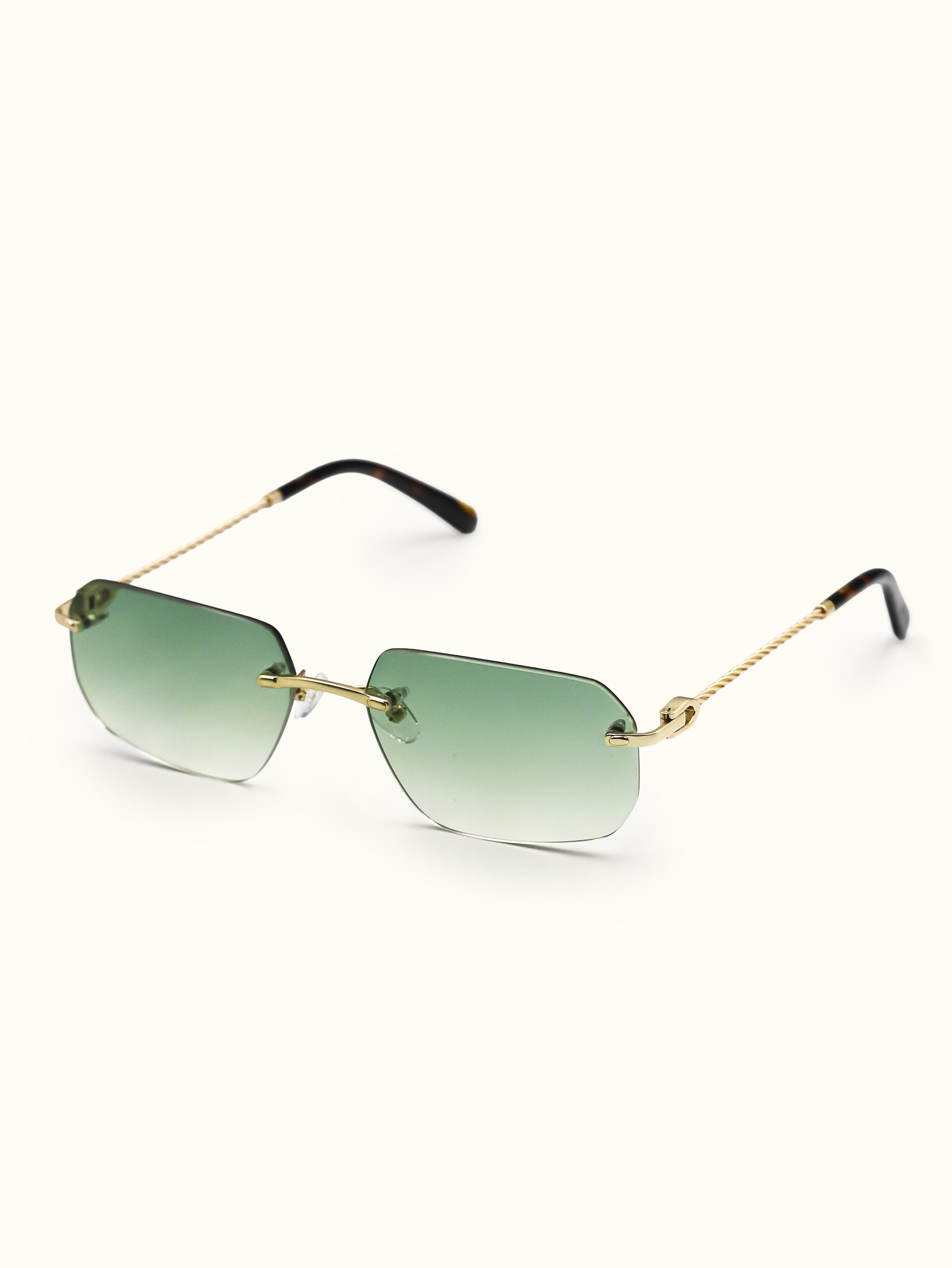 Sunglasses with gold frame and green gradient lenses on a white background